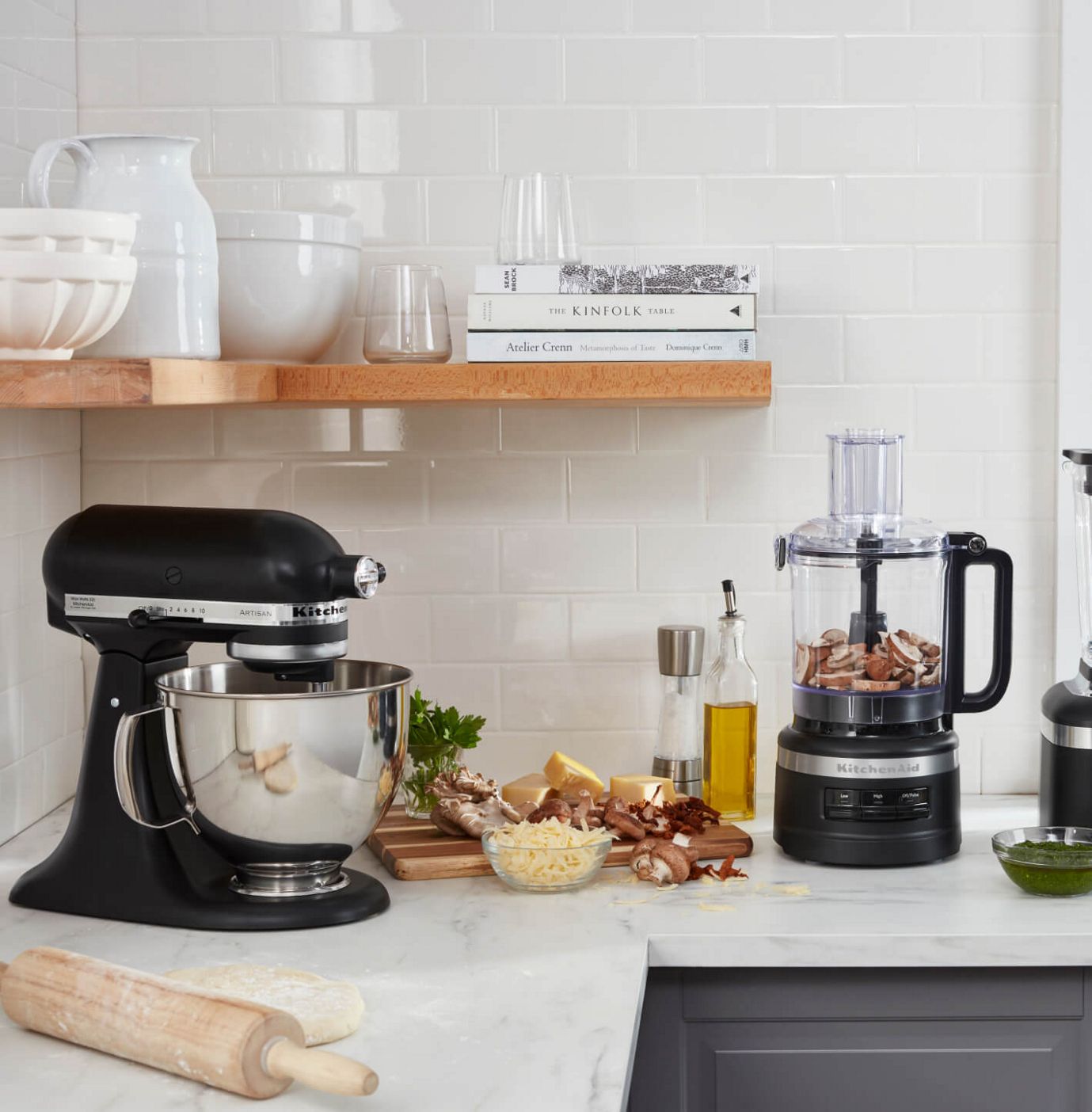 A KitchenAid® stand mixer and countertop food processor in black.